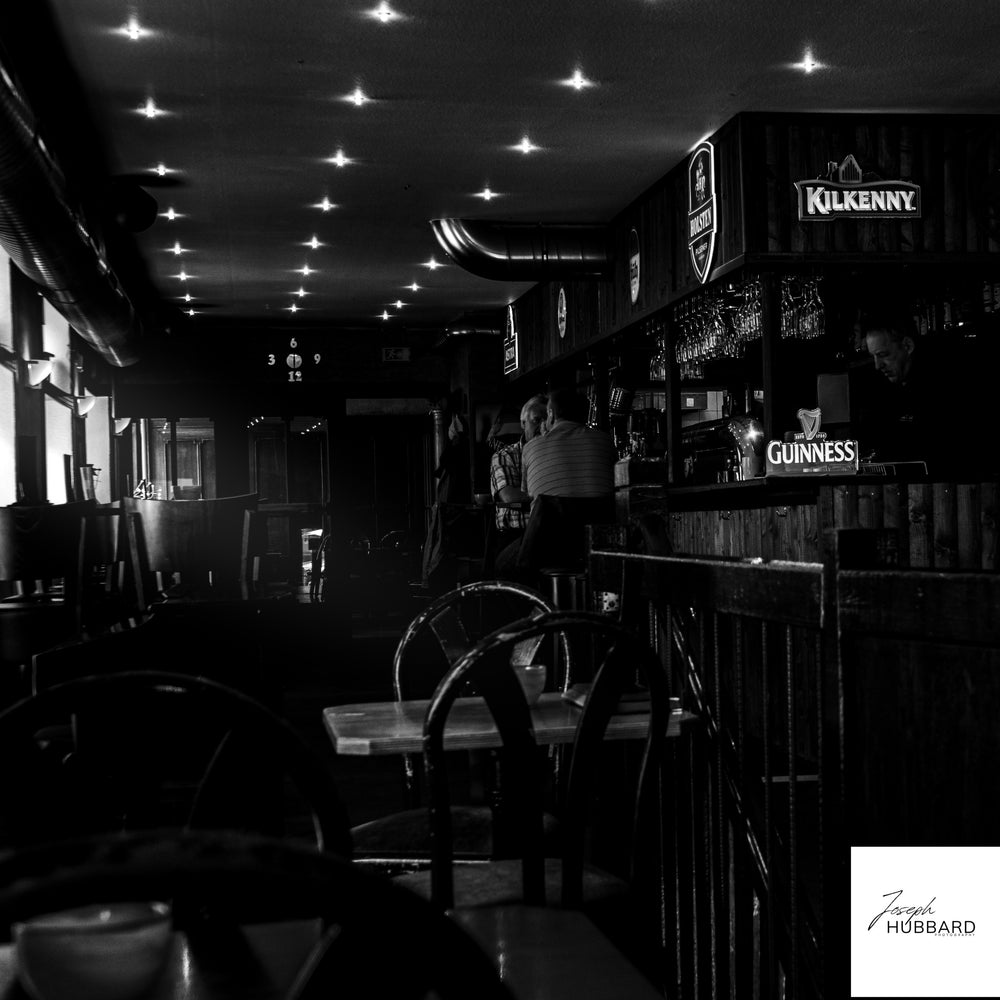 Black and white photograph of a quiet bar interior by Joseph Hubbard